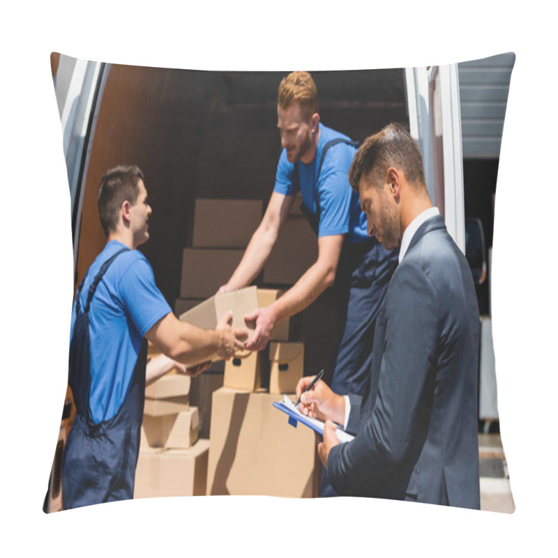 Personality  Selective Focus Of Businessman Writing On Clipboard While Movers Holding Carton Box In Truck Outdoors  Pillow Covers