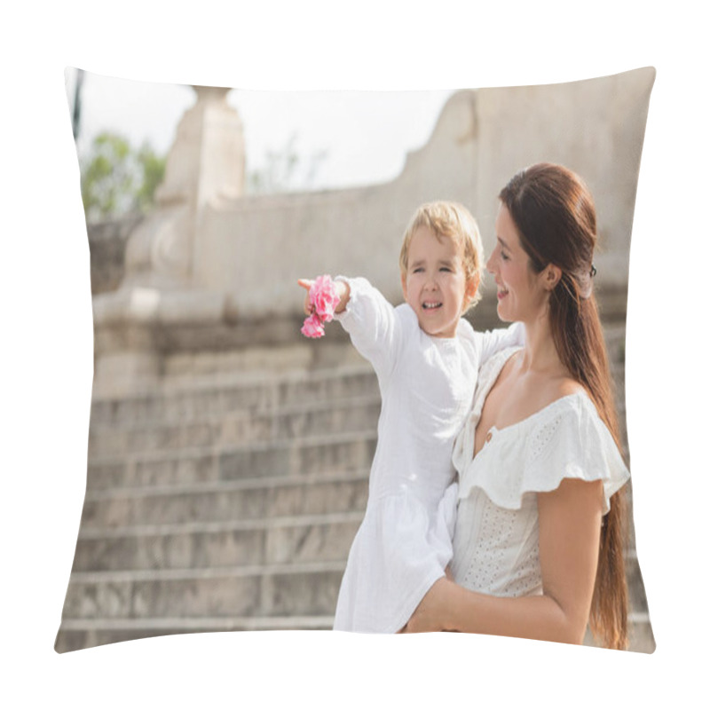 Personality  Cheerful Baby Girl Holding Flowers And Pointing With Finger Near Mom In Summer Dress In Valencia Pillow Covers