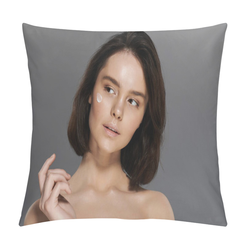 Personality  A Young Woman With Short Dark Hair Applies Moisturizer To Her Cheek Against A Plain Gray Background. Pillow Covers