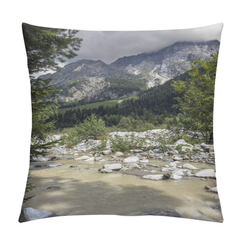 Personality  A Picturesque Mountain Stream Flowing Over Rocks And Boulders, With Dense Forested Hills And Towering Mountains In The Background Under An Overcast Sky. Pillow Covers