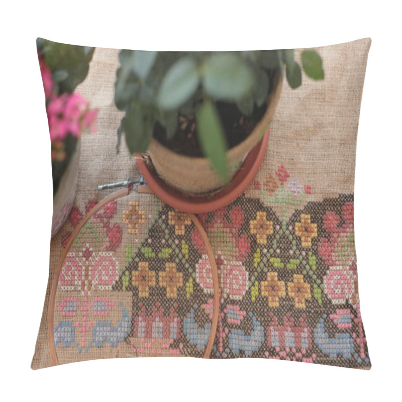 Personality  Traditional Cross Stitched Folk Motif Embroidery On Natural Burlap Fabric Background Closeup On Foreground With Houseplants In Flower Pots On Blurred Foreground. Needlework Embroidery Crafting Hobby Pillow Covers