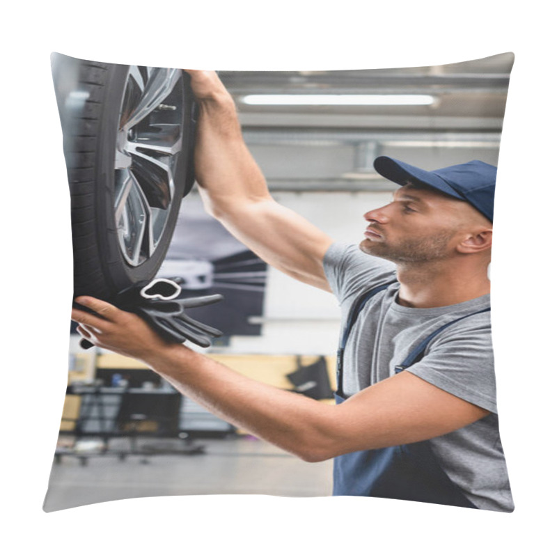 Personality  Side View Of Handsome Technician In Overalls And Cap Looking At Car Tire And Holding Gloves Pillow Covers