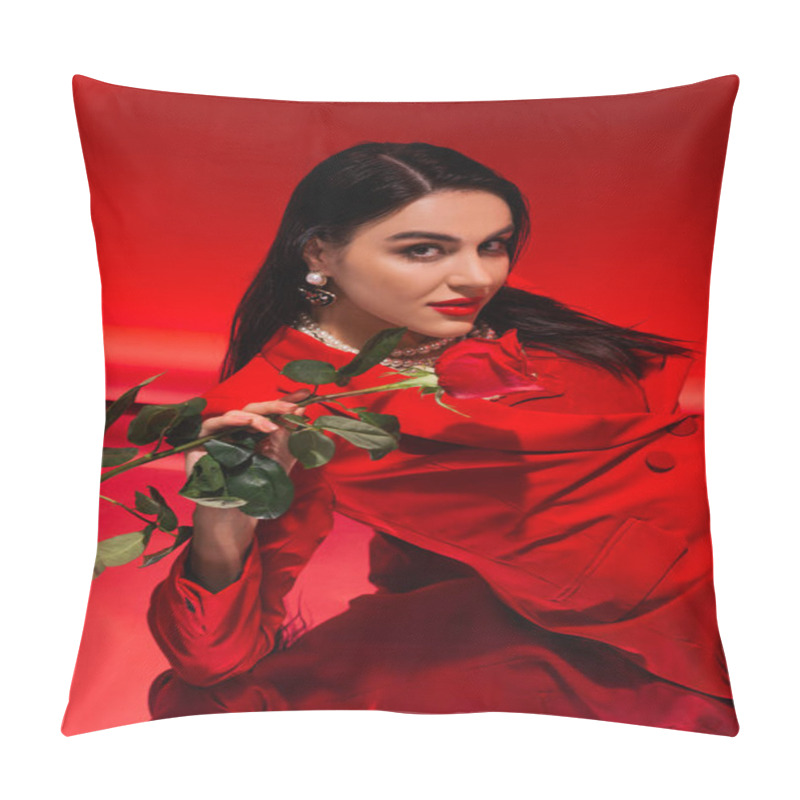 Personality  Pretty Brunette Woman In Jacket Holding Rose And Looking At Camera On Red Background  Pillow Covers