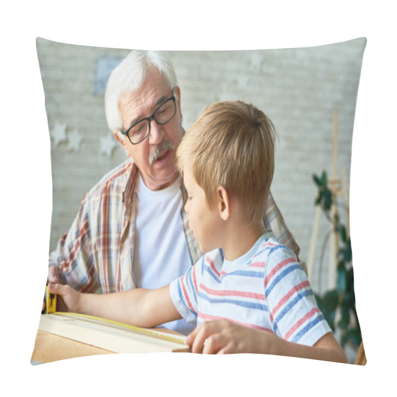 Personality  Portrait Of Grandfather And Little Boy Talking While Making Wooden Model At Desk In Small Studio Pillow Covers