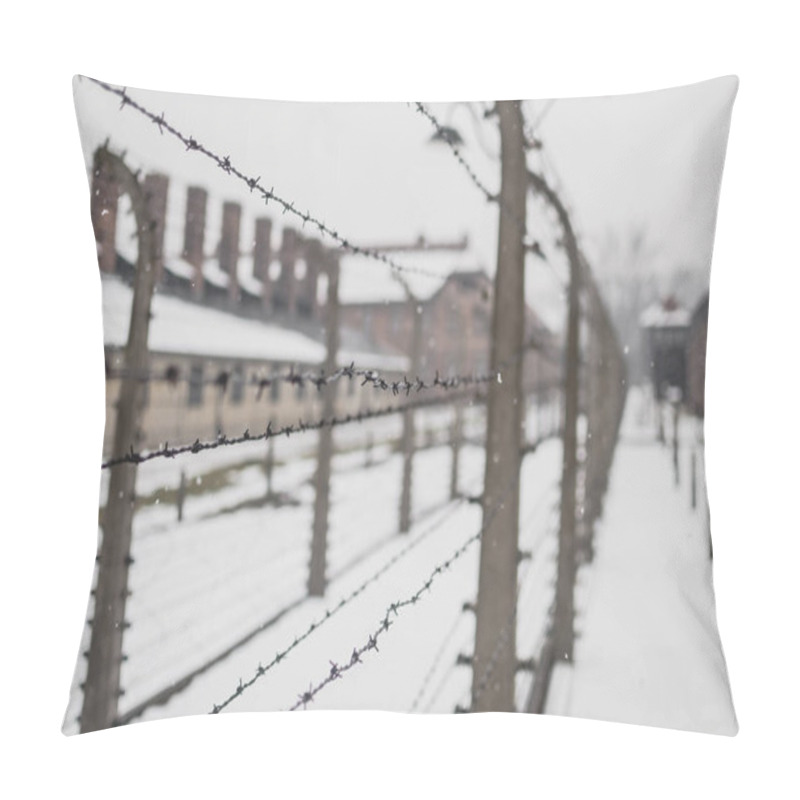 Personality  Oswiecim, Poland - February 16, 2018: Closeup Of Barbed Wire Fence Near The Famous Arch Of The Concentration Camp Auschwitz. Pillow Covers