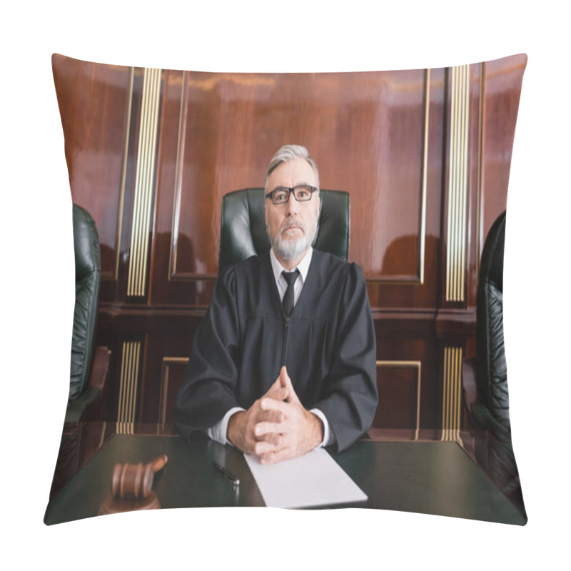 Personality  Senior Judge In Mantle And Eyeglasses Sitting With Clenched Hands Near Gavel And Paper On Desk Pillow Covers