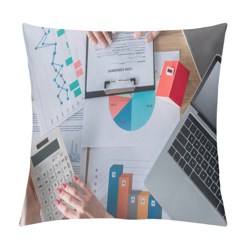 Personality  Cropped Shot Of Man Reading Loan Agreement And Businesswoman Using Calculator While Sitting At Workplace Near Laptop, House Model, Graphs And Charts Pillow Covers