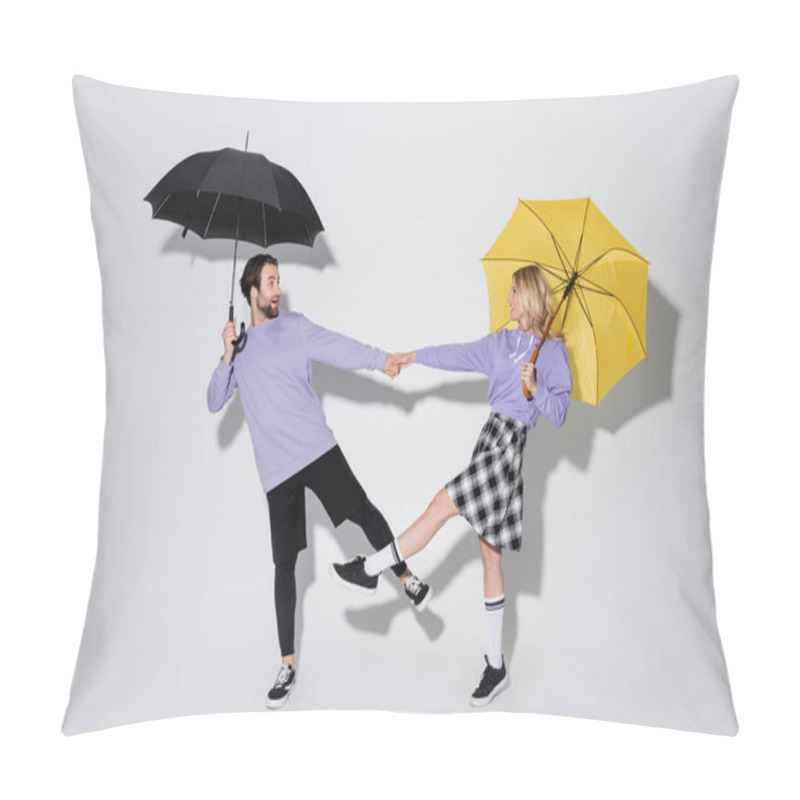 Personality  Full Length Of Happy Couple In Purple Sweatshirts Holding Hands While Standing Under Umbrellas On Grey Pillow Covers