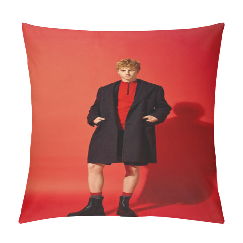 Personality  A Stylish Man Stands Confidently Against A Bright Red Backdrop, Wearing A Cozy Red Pullover Beneath An Elegant Dark Coat. His Look Is Completed With Rugged Black Boots, Radiating Holiday Spirit. Pillow Covers