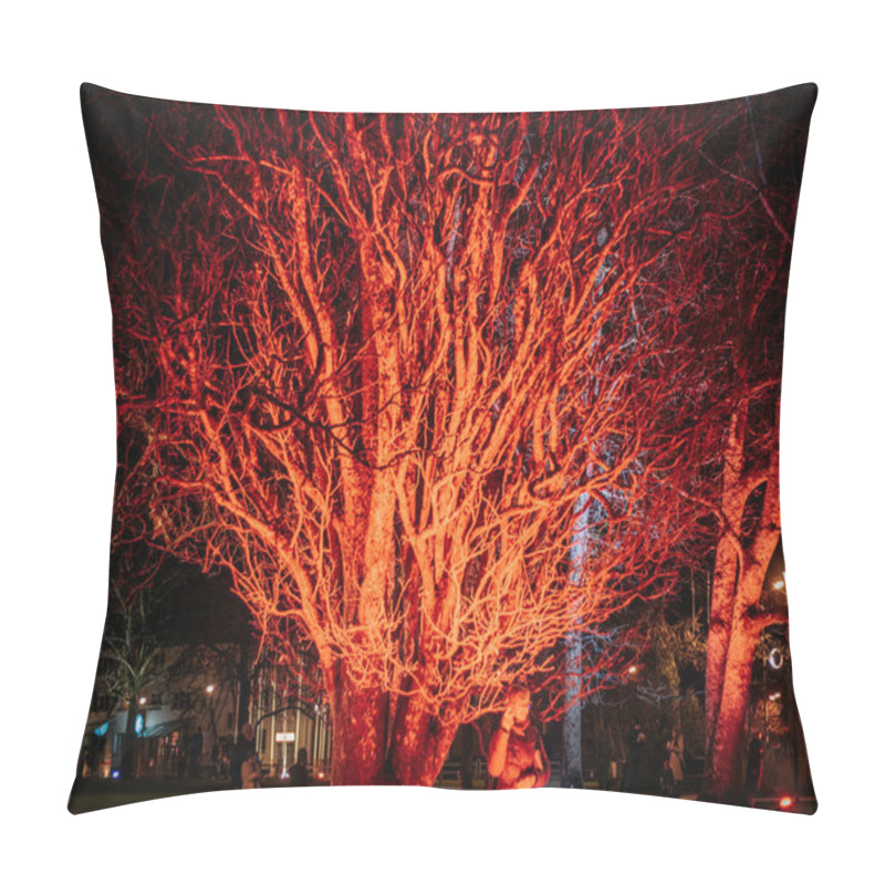 Personality  A Large Tree With Bare Branches Glowing Brightly Red At Night, Surrounded By Dimly Lit Streetlights. City Buildings Visible In The Background. No Recognizable People Or Logos. Pillow Covers