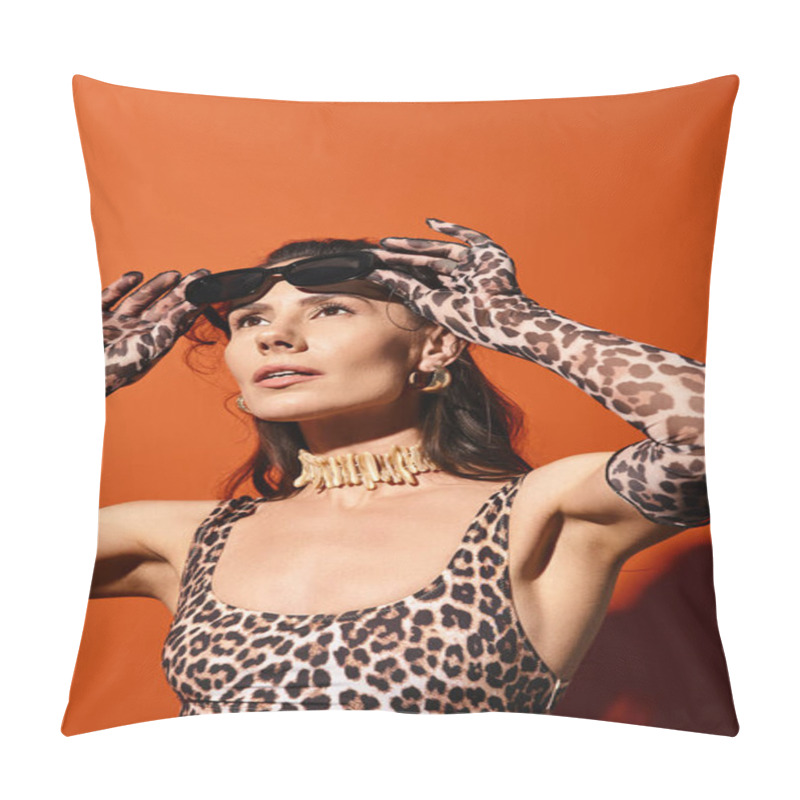 Personality  A Stylish Woman In A Leopard Print Top Holds Her Hands On Her Head In A Vibrant Orange Studio During A Summertime Fashion Shoot. Pillow Covers