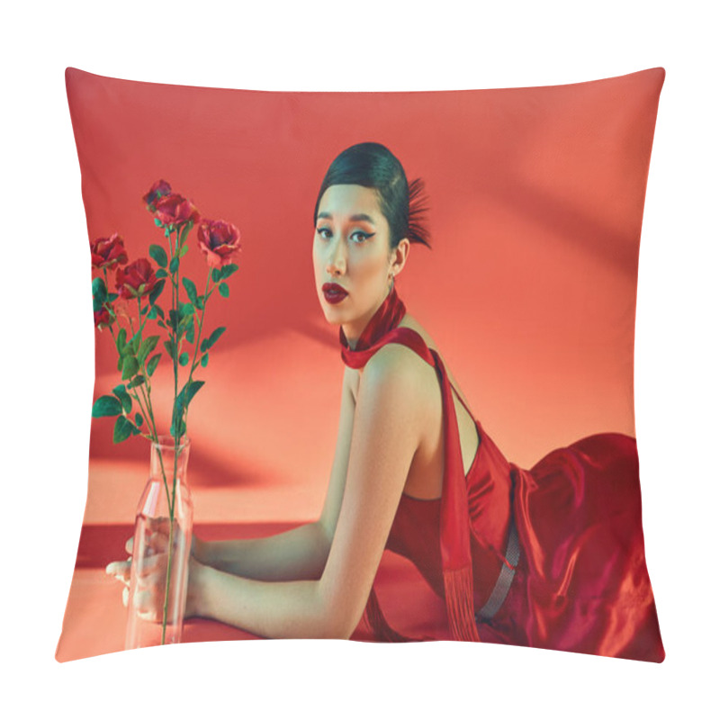 Personality  Spring Fashion Concept, Young And Elegant Asian Woman With Bold Makeup, In Neckerchief And Dress Lying Near Glass Vase With Roses And Looking At Camera On Red Background With Lighting Pillow Covers