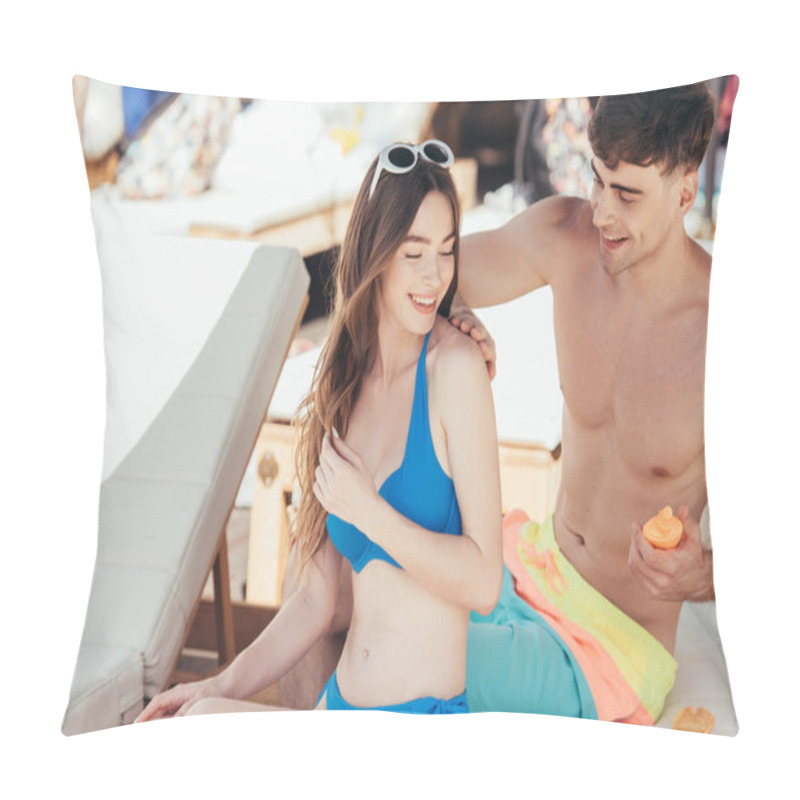 Personality  Young Man Applying Sunscreen Lotion On Shoulder Of Smiling Girlfriend  Pillow Covers