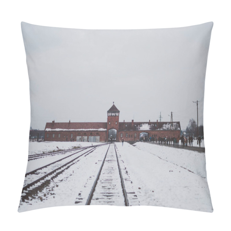 Personality  Oswiecim, Poland - February 16, 2018: Railway Tracks Of Auschwitz Concentration Camp, The Famous Watchtower, And Visitors Pillow Covers