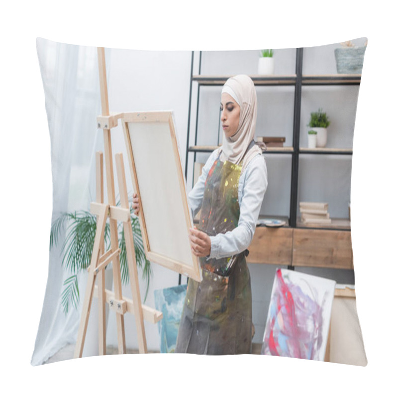 Personality  Muslim Woman In Hijab And Apron Holding Canvas Near Easel At Home Pillow Covers