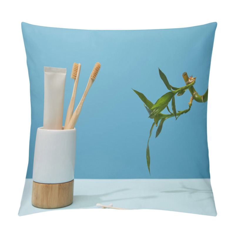 Personality  Holder With Toothbrushes, Toothpaste In Tube, Ear Sticks And Green Bamboo Stem On Table And Blue Background Pillow Covers