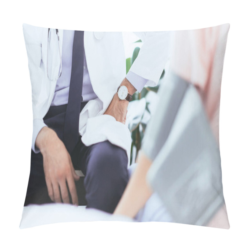 Personality  Cropped Shot Of Doctor Sitting In Front Of Patient With Blood Pressure Gauge On Hand Pillow Covers