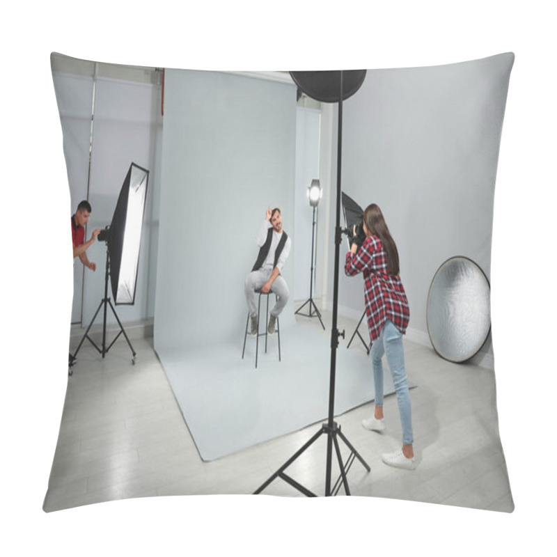 Personality  Professional Photographer With Assistant Taking Picture Of Young Man In Modern Studio Pillow Covers