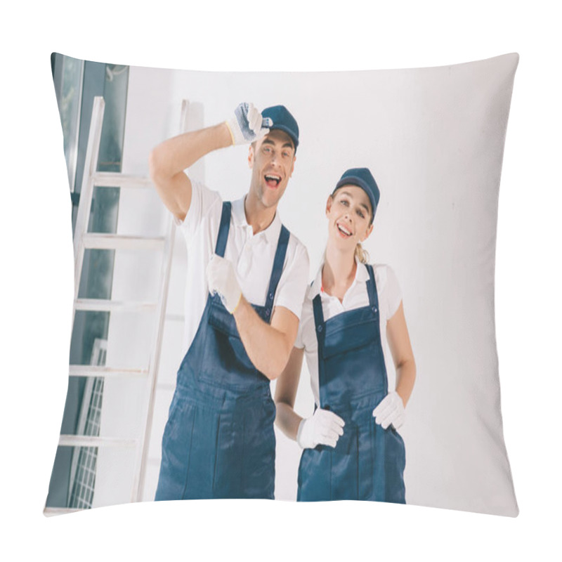 Personality  Cheerful Painter Showing Small Amount Gesture While Standing Near Attractive Colleague Pillow Covers