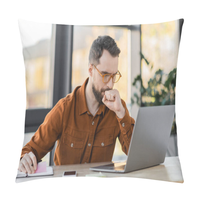 Personality  Thoughtful Bearded Businessman In Eyeglasses Holding Pen With Sticky Notes And Looking At Laptop Near Cellphone With Blank Screen And Notebook On Work Desk In Office Pillow Covers