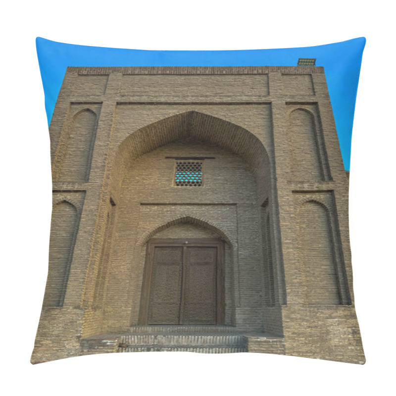 Personality  An Ancient Brick Structure With An Intricately Carved Wooden Door, Surrounded By Elegant Arches And Geometric Patterns. The Building Exhibits Traditional Architectural Style Under A Clear Blue Sky. Pillow Covers