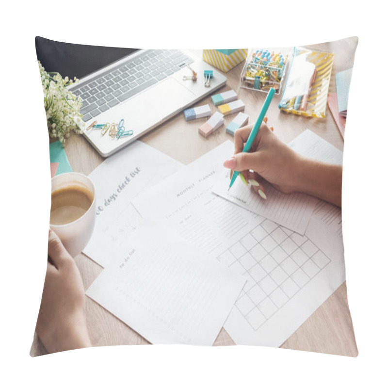 Personality  Cropped View Of Woman Holding Cup Of Coffee In Hand, Sitting Behind Wooden Table With Laptop And Stationery, Writing In Paper Planners Pillow Covers