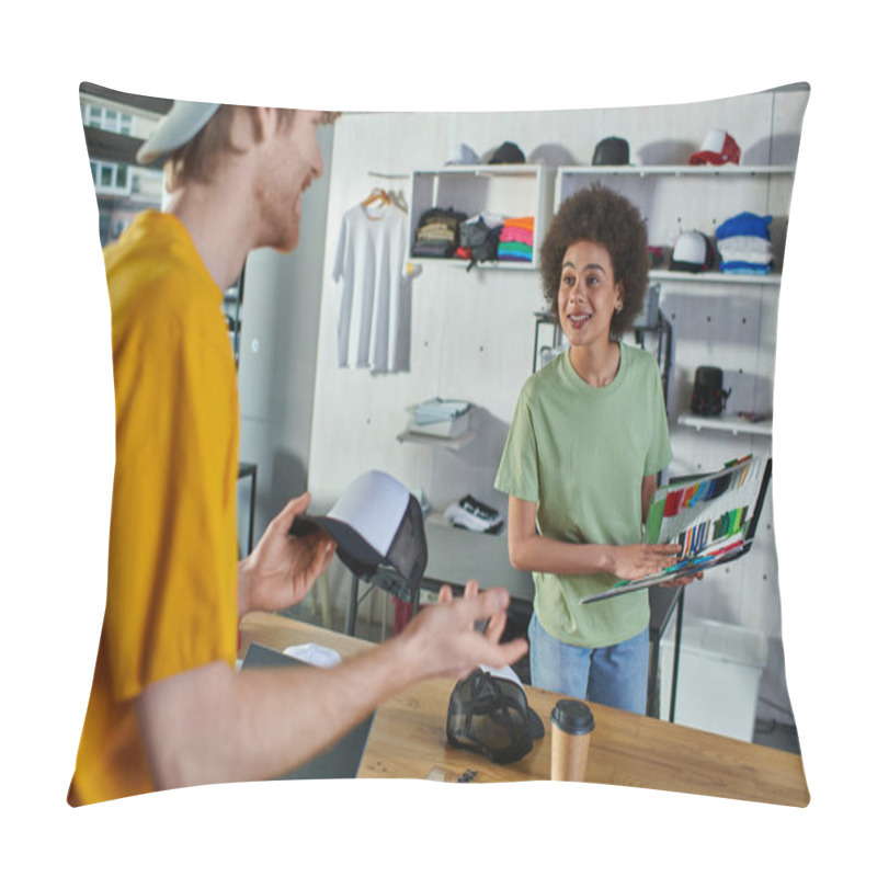 Personality  Smiling Young African American Designer Holding Cloth Samples Near Blurred Colleague With Snapback And Laptop With Blank Screen In Print Studio, Hands-on Entrepreneurship Concept  Pillow Covers