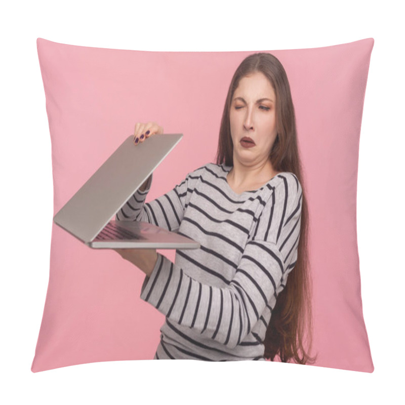 Personality  Portrait Of Displeased Girl In Striped Sweatshirt Closing Laptop, Looking With Suspicious And Distrust At Screen, Scared Of Unknown Software, Failure, Program Bug. Indoor Studio Shot, Pink Background Pillow Covers