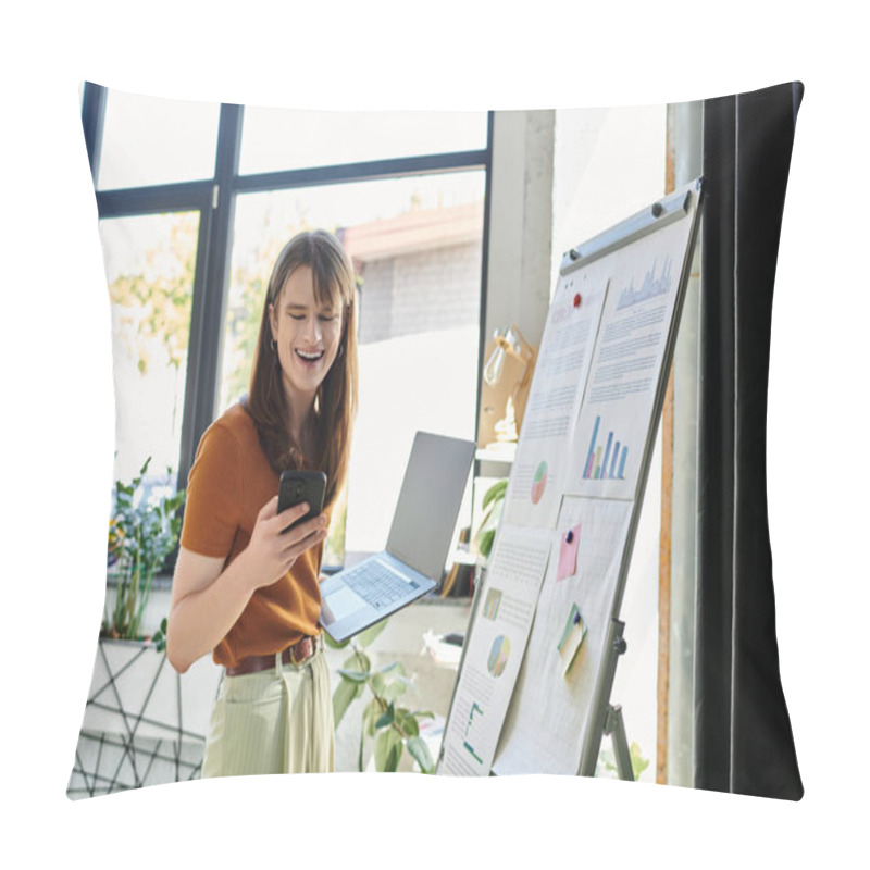 Personality  A Young Non Binary Person Smiles While Multitasking With A Laptop And Phone In A Bright Office. Pillow Covers