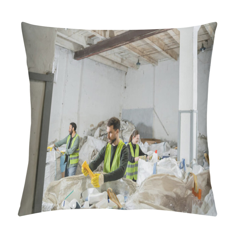 Personality  Male Worker In Protective Vest And Gloves Holding Plastic Trash While Standing Near Sacks And Blurred Interracial Colleagues In Waste Disposal Station, Garbage Sorting And Recycling Concept Pillow Covers