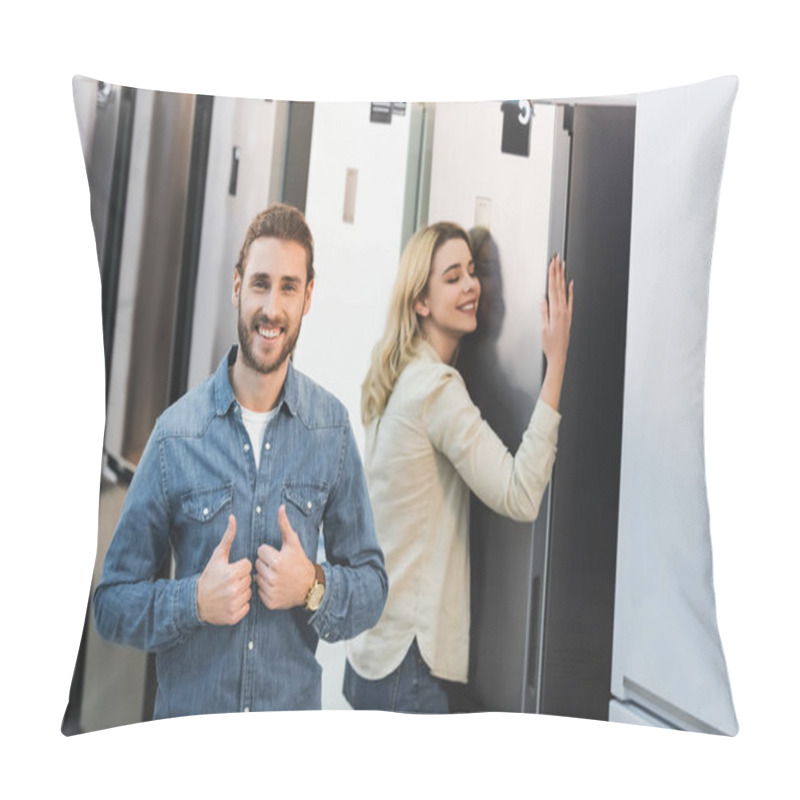 Personality  Selective Focus Of Smiling Boyfriend Showing Likes And Girlfriend Touching On Background In Home Appliance Store  Pillow Covers