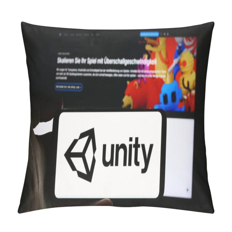 Personality  Stuttgart, Germany - 08-09-2024: Person Holding Cellphone With Logo Of US Video Games Company Unity Software Inc. In Front Of Business Webpage. Focus On Phone Display. Pillow Covers