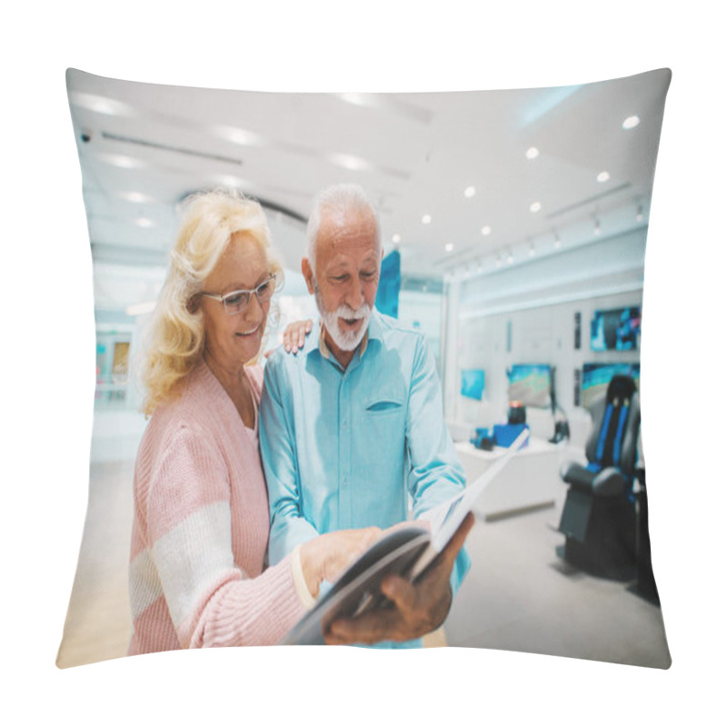 Personality  Happy Caucasian Senior Couple Looking At Brochure And Choosing What To Buy While Standing In Tech Store. Pillow Covers