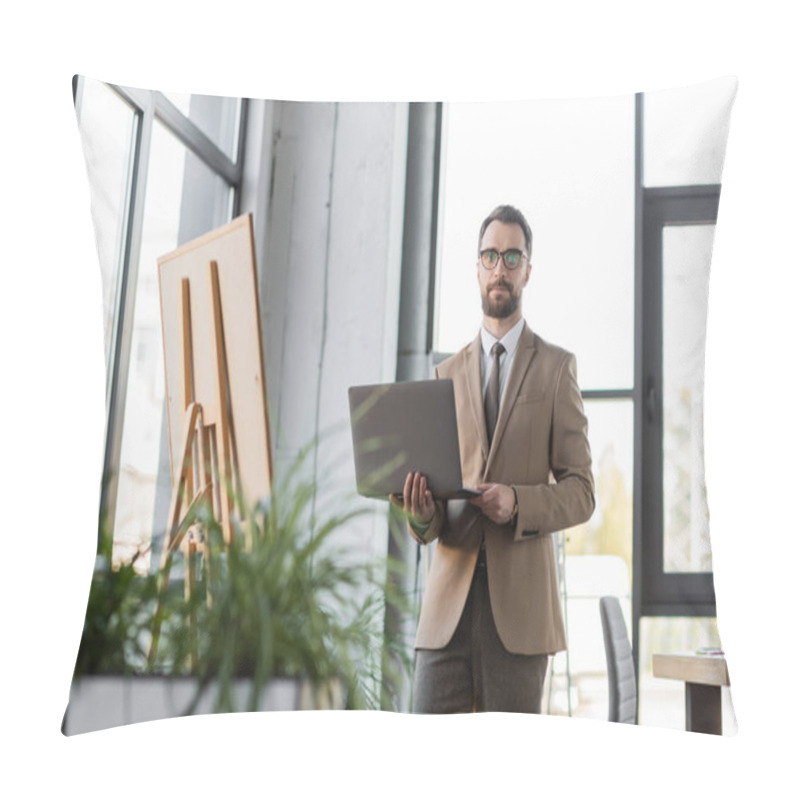 Personality  Ambitious Bearded Businessman In Eyeglasses, Beige Blazer And Tie Standing With Laptop And Looking At Camera Near Flip Chart, Large Windows And Blurred Plants In Office Pillow Covers