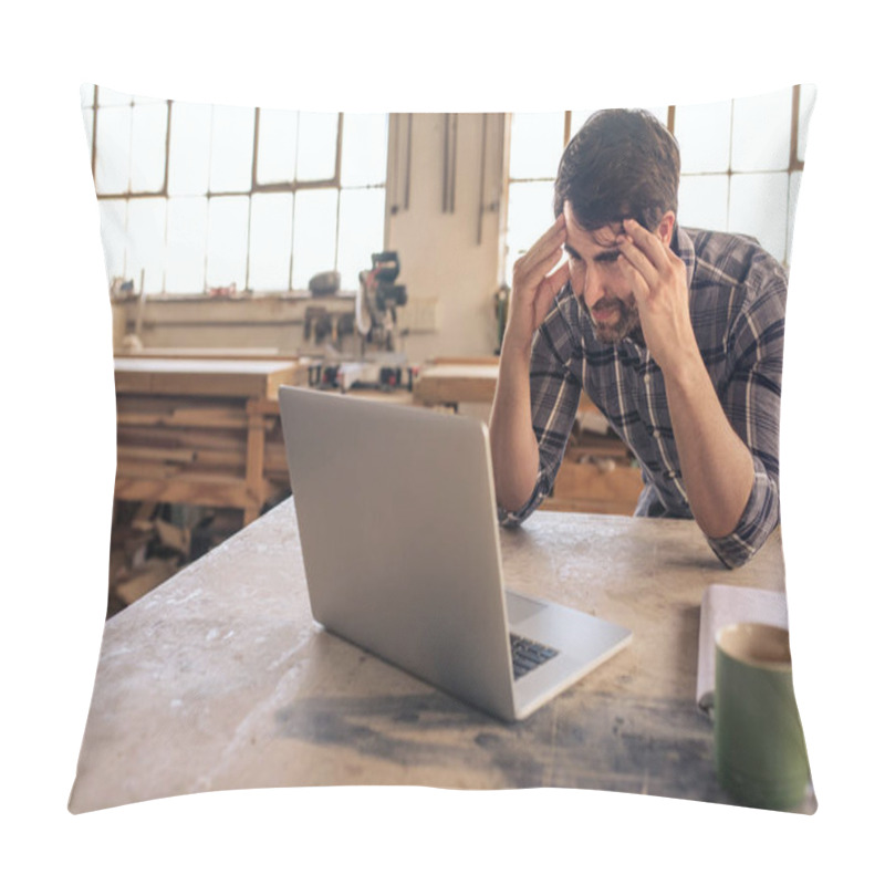 Personality  Young Woodworker Looking Stressed While Leaning At A Workbench In His Carpentry Studio Using A Laptop Pillow Covers