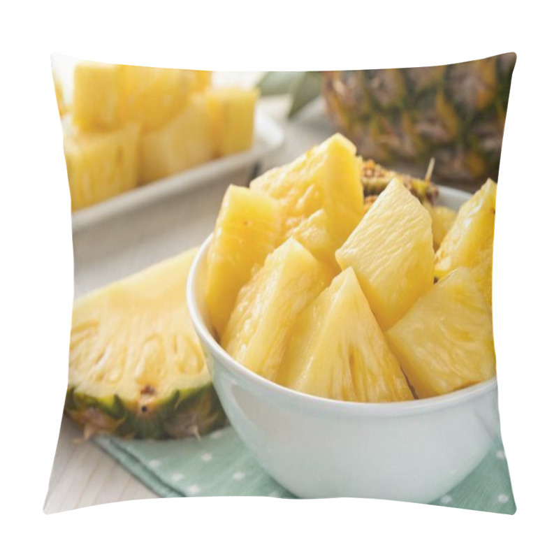 Personality  A Photo Of A Still Life Featuring A Close-up Of A Bowl Filled With Fresh, Yellow Pineapple Slices. The Bowl Is White And Placed On A Surface With A Patterned Cloth Underneath. A Partially Sliced Pineapple Lies Next To The Bowl. The Background Consist Pillow Covers