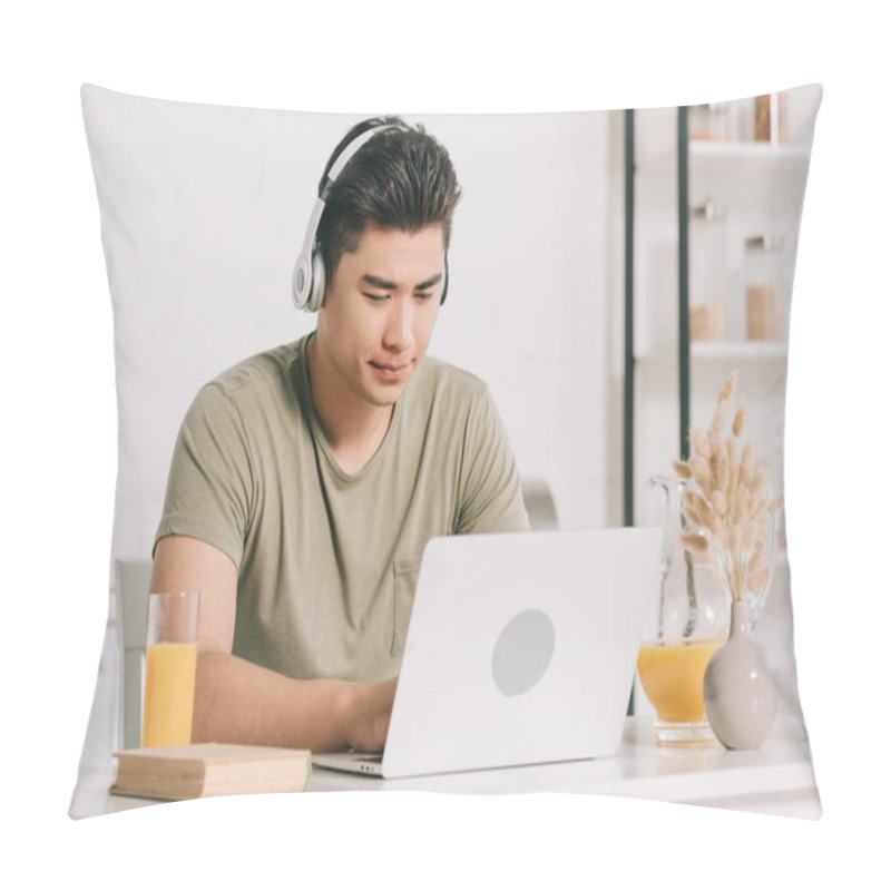 Personality  Concentrated Asian Man In Headphones Using Laptop While Sitting At Kitchen Table Pillow Covers