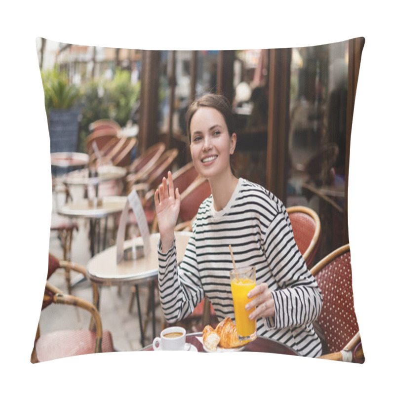 Personality  Smiling Woman In Striped Long Sleeve Shirt Holding Glass Of Orange Juice And Waving Hand In Outdoor Cafe In Paris Pillow Covers