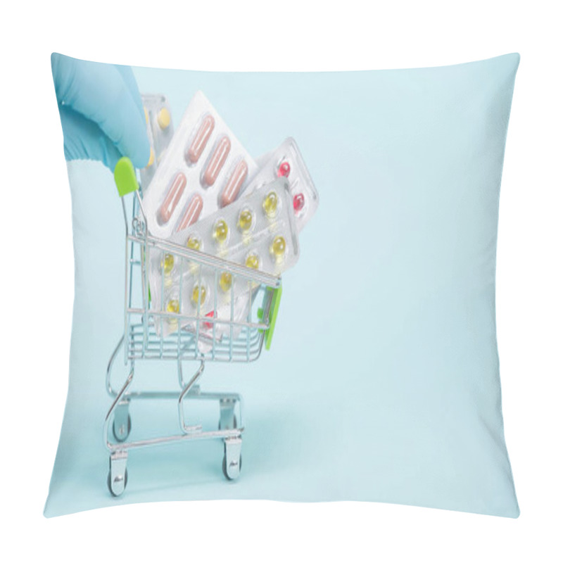 Personality  Cropped View Of Person In Latex Glove Holding Small Shopping Cart With Pills On Blue Background  Pillow Covers