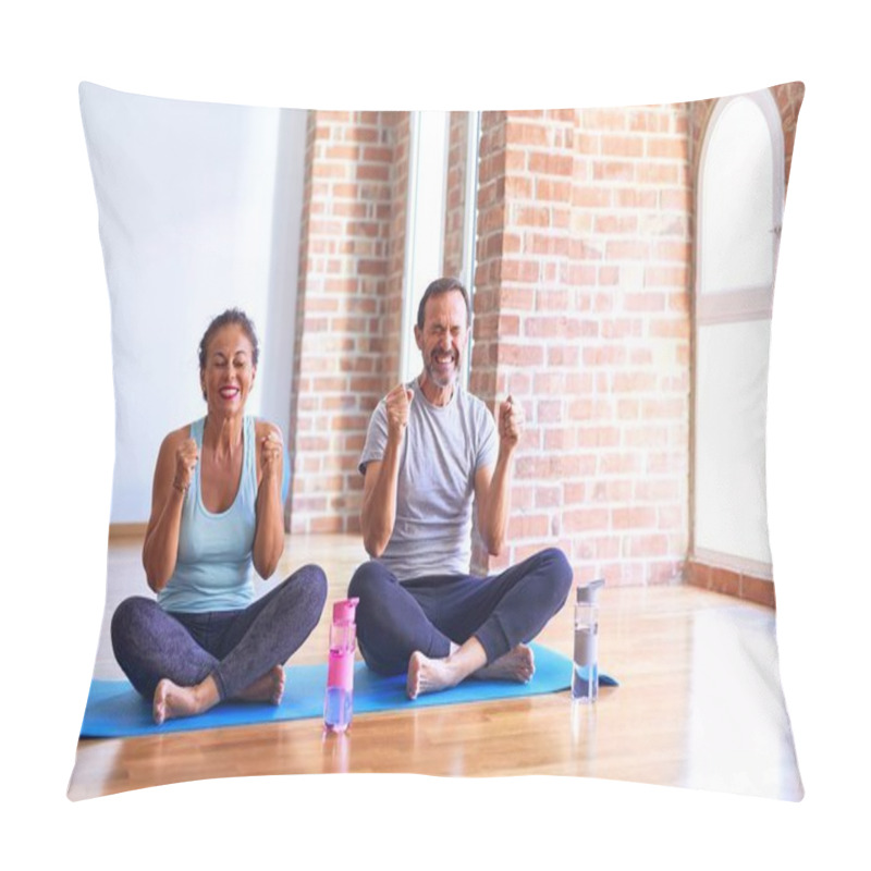 Personality  Middle Age Sporty Couple Sitting On Mat Doing Stretching Yoga Exercise At Gym Excited For Success With Arms Raised And Eyes Closed Celebrating Victory Smiling. Winner Concept. Pillow Covers