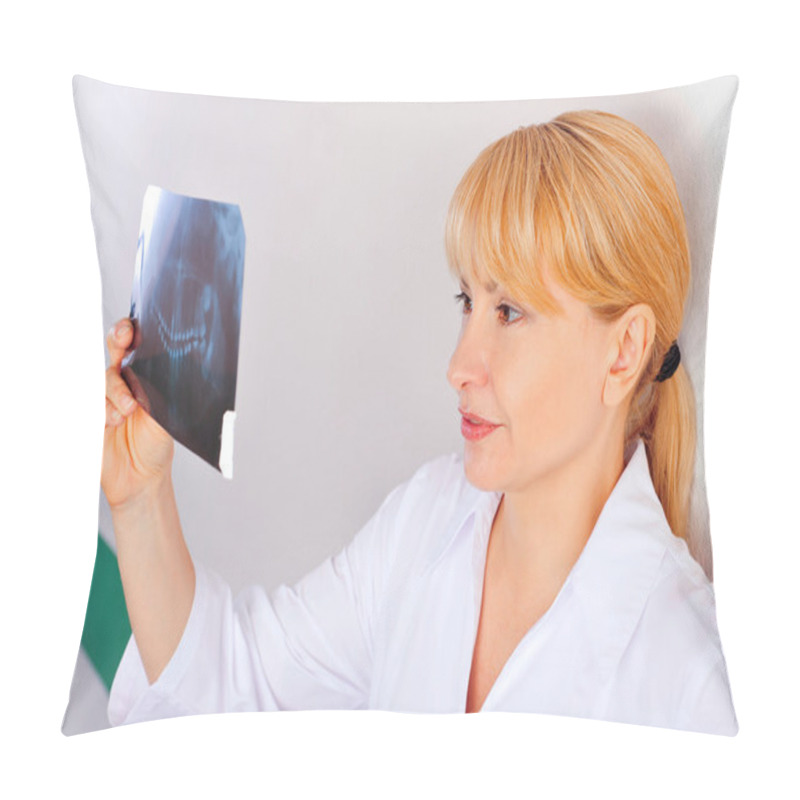 Personality  Portrait Of Smiling Caucasian Woman Doctor Wearing Uniform Standing Against Wall At Hospital Looking At Xray Results Of Her Patient Pillow Covers