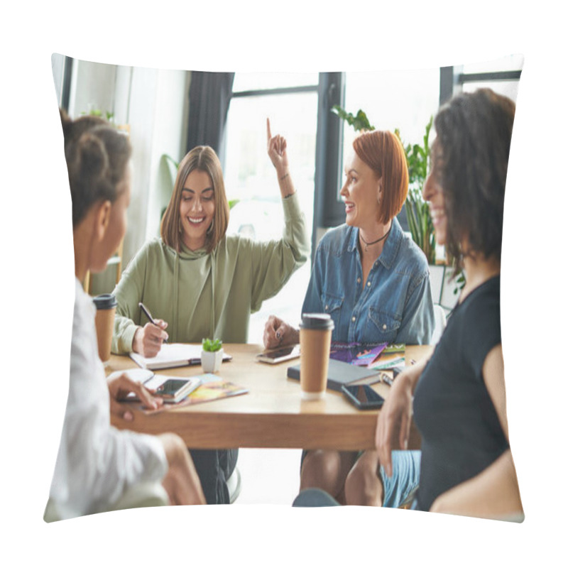 Personality  Cheerful Young Woman Showing Idea Gesture And Writing In Notebook Near Multiethnic Friends And Table With Paper Cups And Magazines In Female Interest Club, Knowledge-sharing And Socializing Concept Pillow Covers