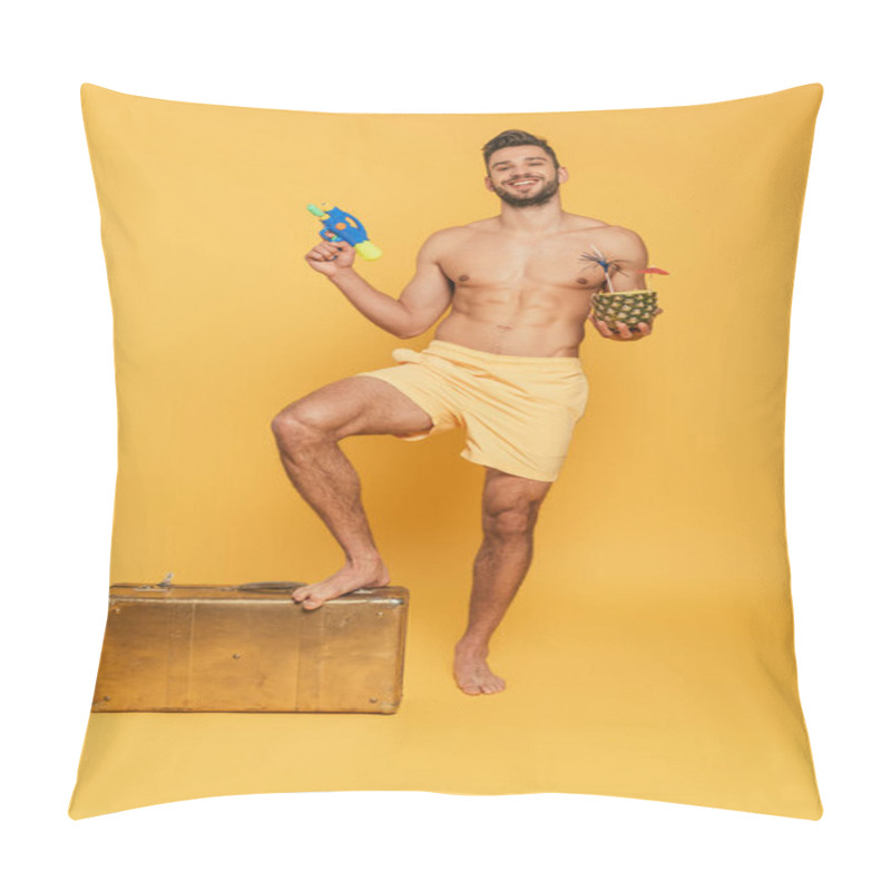 Personality  Happy Shirtless Man Holding Water Gun Cocktail In Pineapple While Stepping On Vintage Suitcase On Yellow Background Pillow Covers