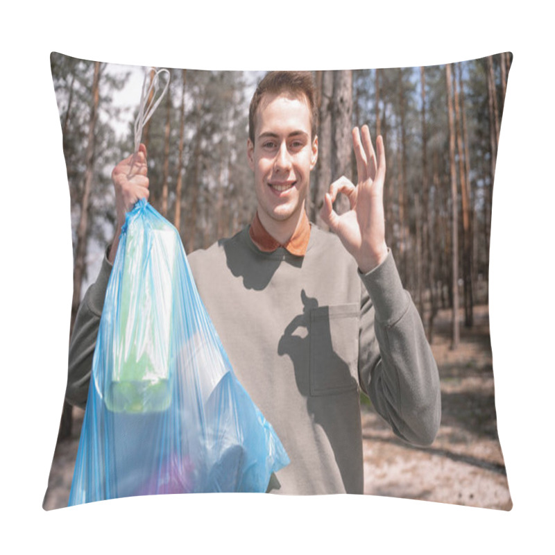 Personality  Happy Young Man Holding Blue Trash Bag And Showing Ok Sign In Forest  Pillow Covers