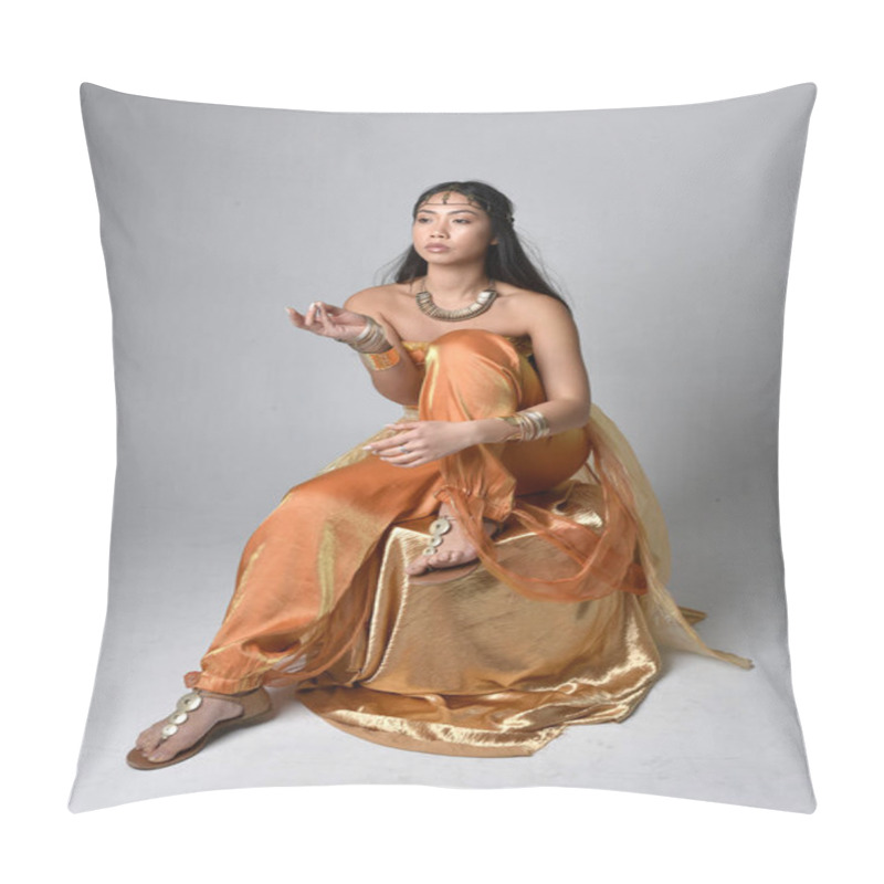 Personality  Full Length Portrait Of Pretty Young Asian Woman Wearing Golden Arabian Robes Like A Genie, Seated Pose, Isolated On Studio Background. Pillow Covers