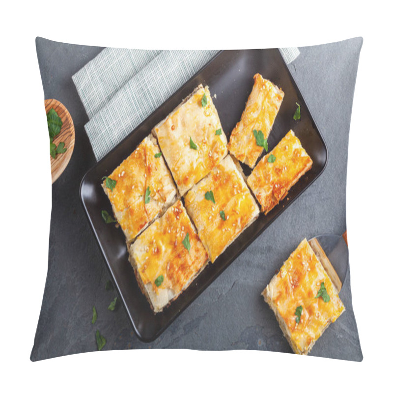 Personality  Turkish Kiymali Borek Served On A Tray After Being Sliced Into Square Shapes. Fresh Parsley Leaves Are Sprinkled On Top For Added Flavor. One Slice Is On A Spatula For Serving. Made With Phyllo Dough Pillow Covers