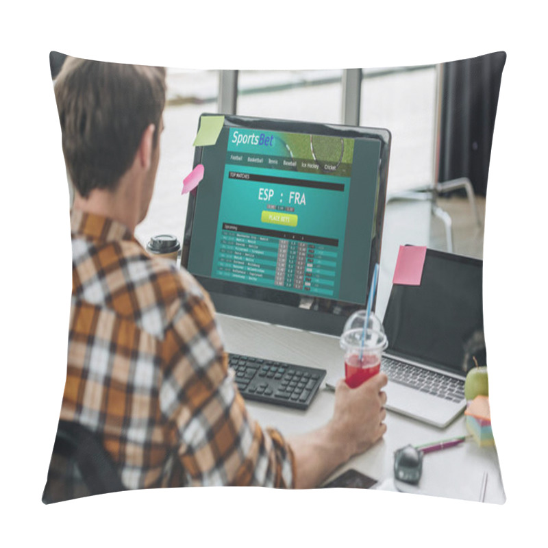 Personality  KYIV, UKRAINE - JULY 29, 2019:  Back View Of Young Programmer Holding Glass Of Juice While Sitting At Workplace Near Computer Monitor With Sportsbet Website On Screen Pillow Covers