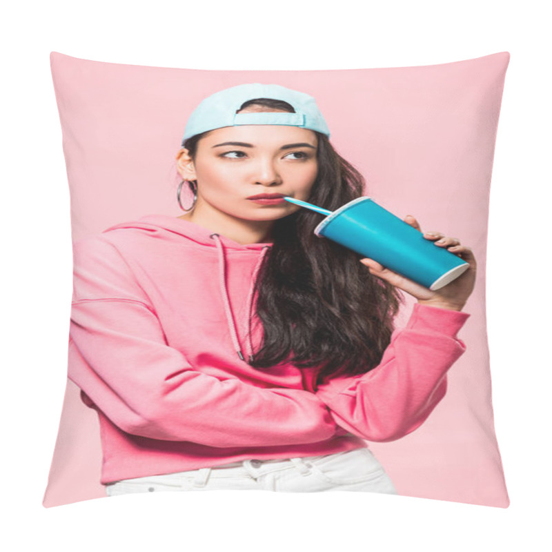 Personality  Pensive Asian Woman In Pullover And Cap Drinking From Plastic Cup Isolated On Pink  Pillow Covers