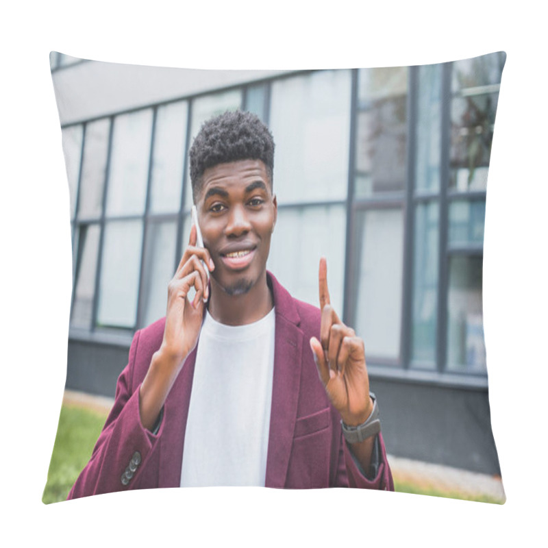 Personality  Smiling Young Man Talking By Phone While Looking At Camera And Pointing Up On Street Pillow Covers