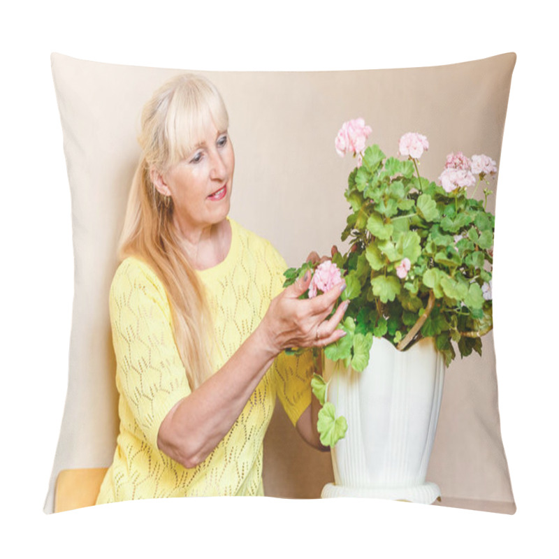 Personality  Fifty-year-old Beautiful Caucasian Woman Admires Blooming Pink Pelargonium In Pots Pillow Covers